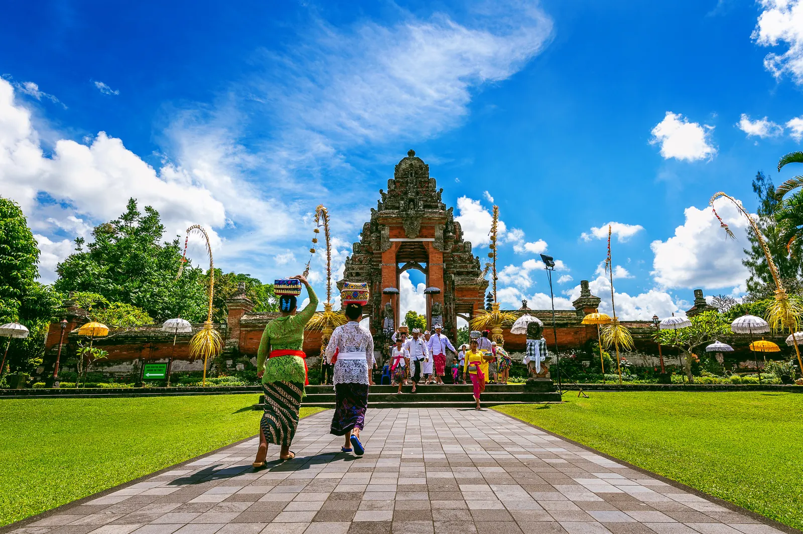 Balinese temple gate with a ceremony procession